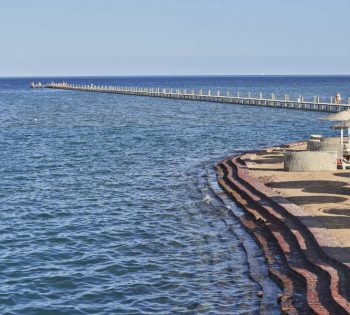 Zeytouna beach in El Gouna with jetty over Red Sea water and sunbeds