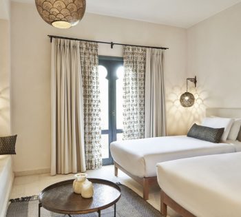 Rennovated Ali Pasha Hotel Premium Room, with twin beds, a sofa, arabesque style lamps, patterned cushions & room accessories