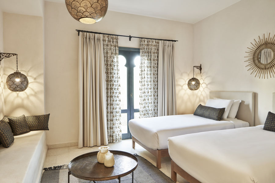 Rennovated Ali Pasha Hotel Premium Room, with twin beds, a sofa, arabesque style lamps, patterned cushions & room accessories