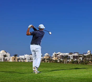 a golfer swimming on Golf Green in El Gouna Red Sea town