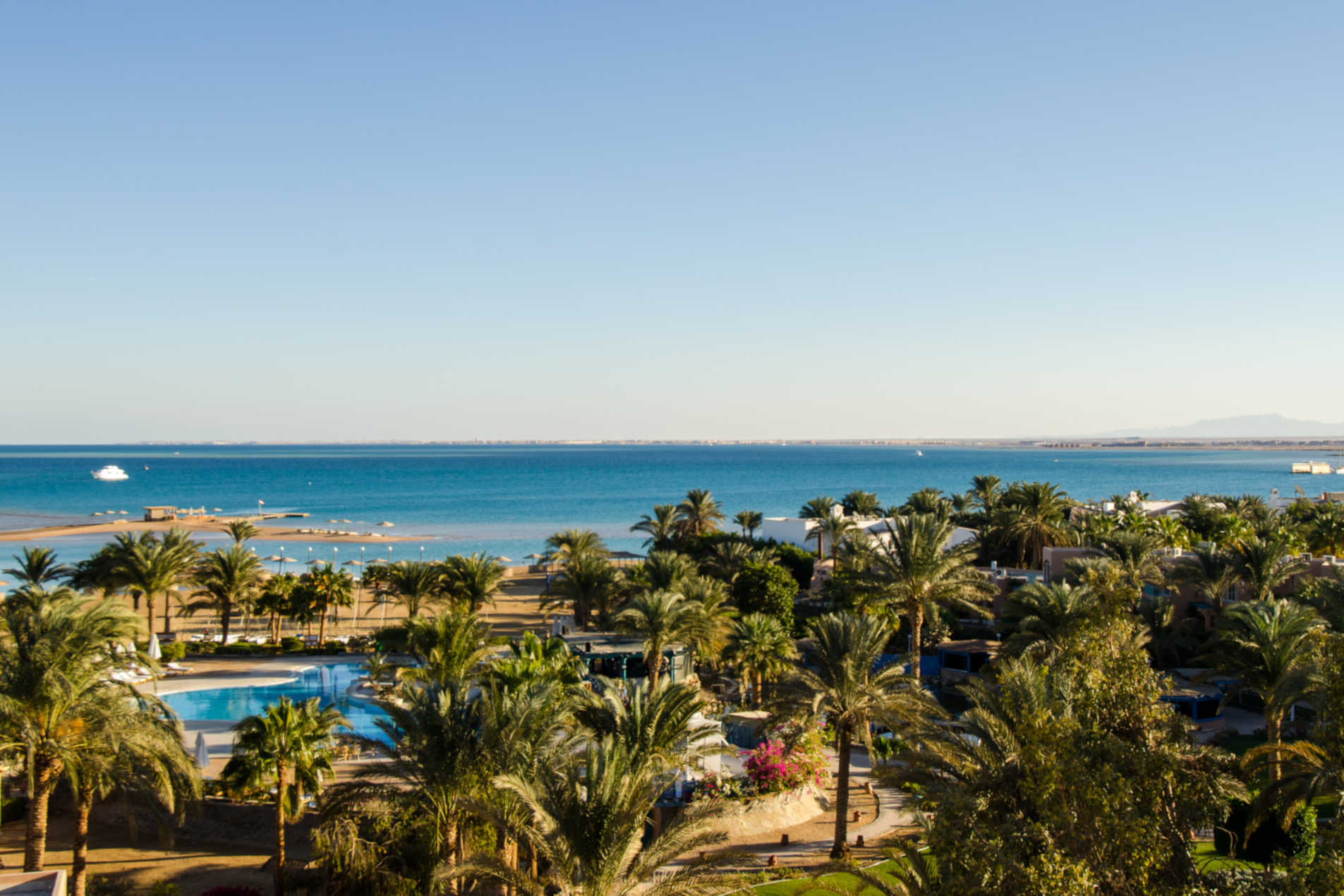 an overview of club paradisio hotel's pool and beach