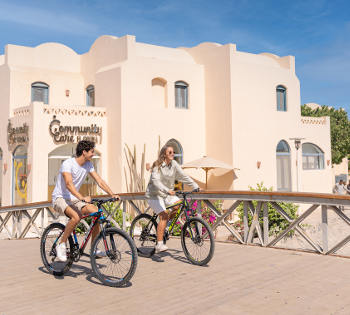 men and women biking in front of el gouna downtown info center