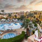 overview of three corners rihana inn hotel's pool and buildings