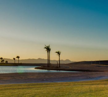 green golf course with water pool at ancient sands golf resort in el gouna