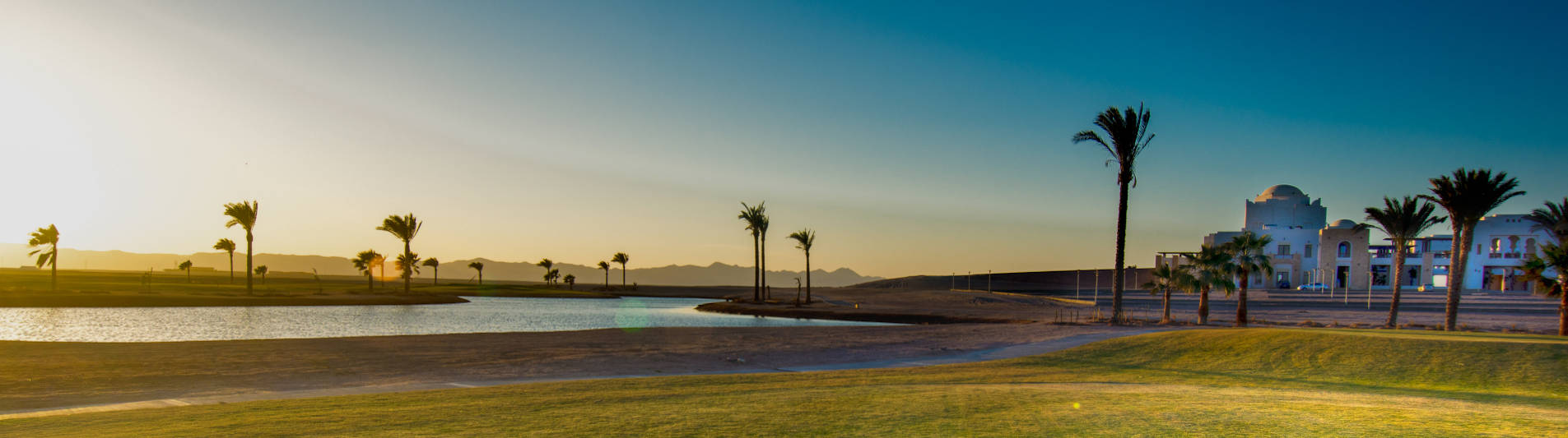 green golf course with water pool at ancient sands golf resort in el gouna