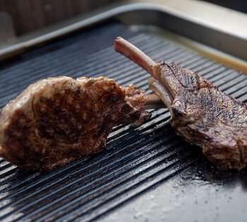 2 beef ribs cooked on a grill