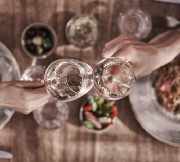 outdoor restaurant couple hands cheers food