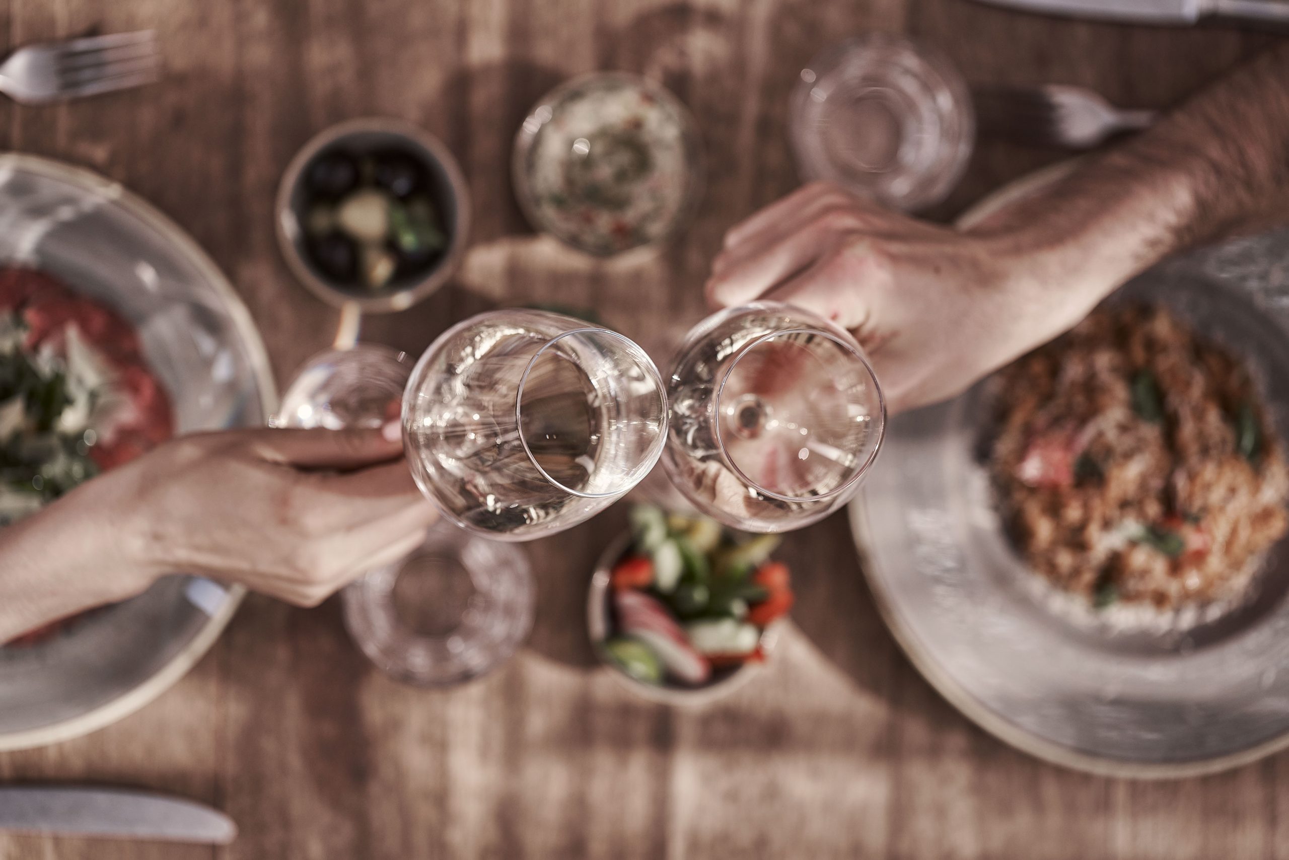 outdoor restaurant couple hands cheers food