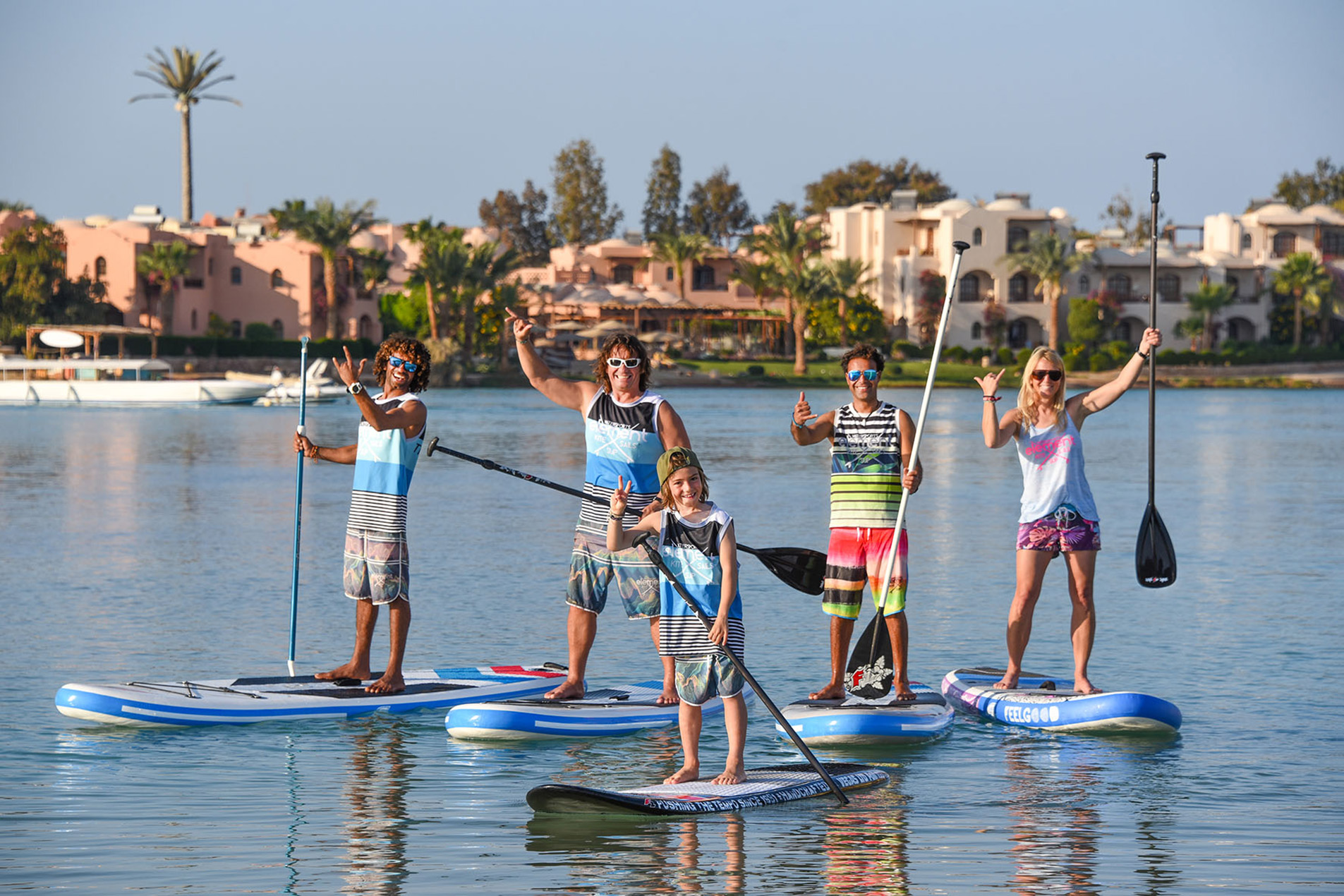 Group of People Practicing Standing Kayaking.