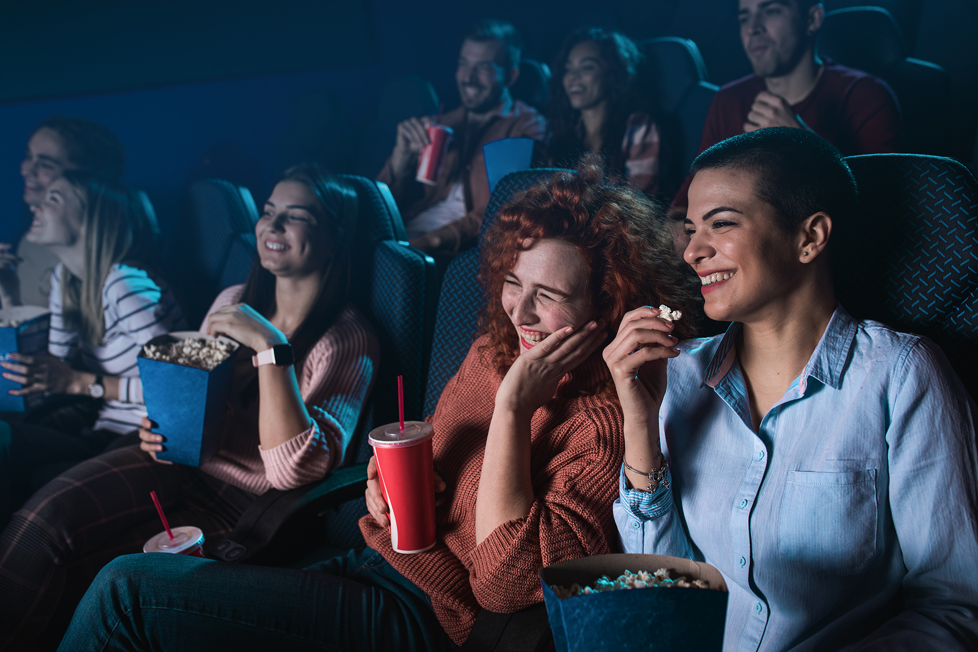 Group of Girls enjoying a Film at the cinema.