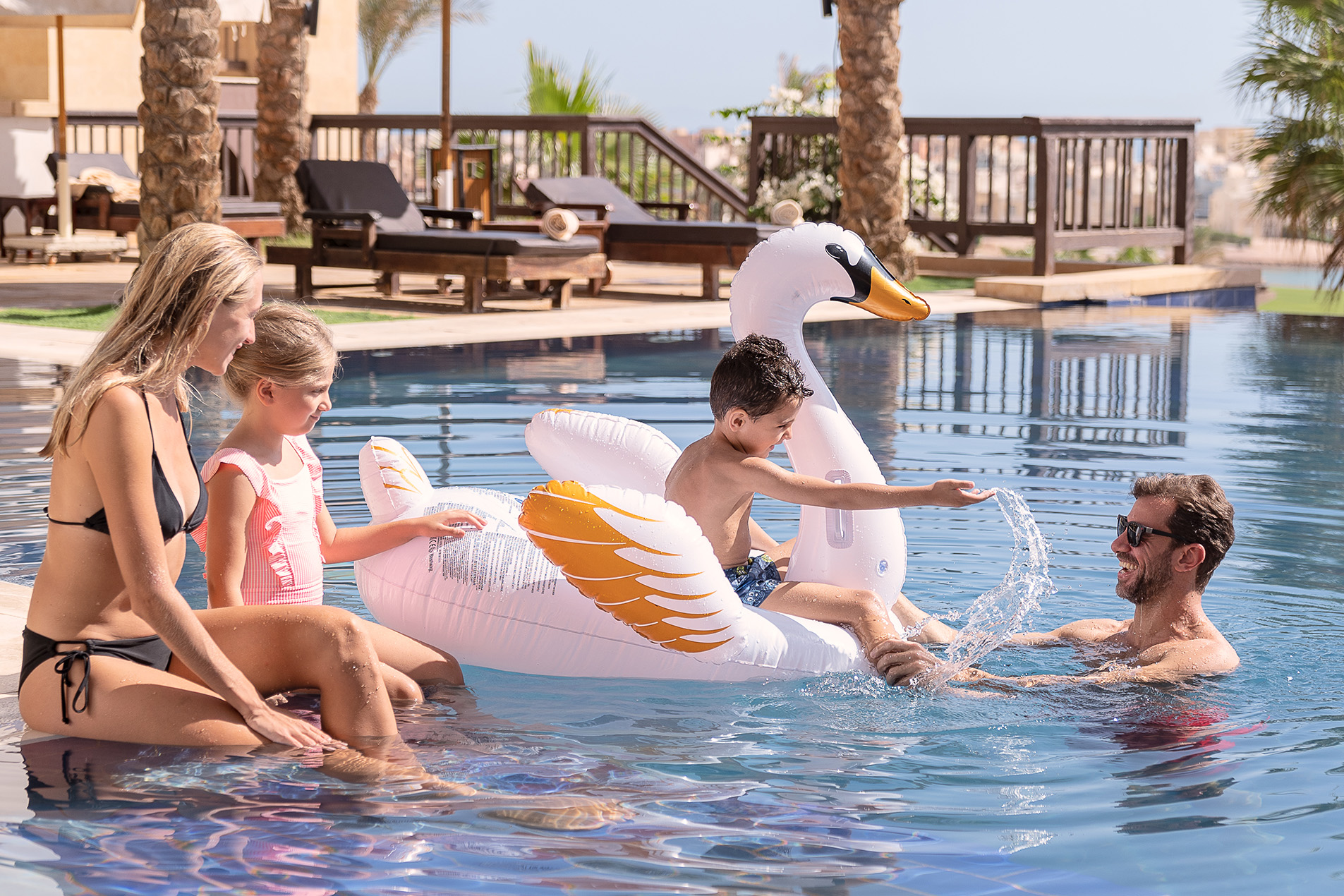a beautiful family enjoying their time in the pool.