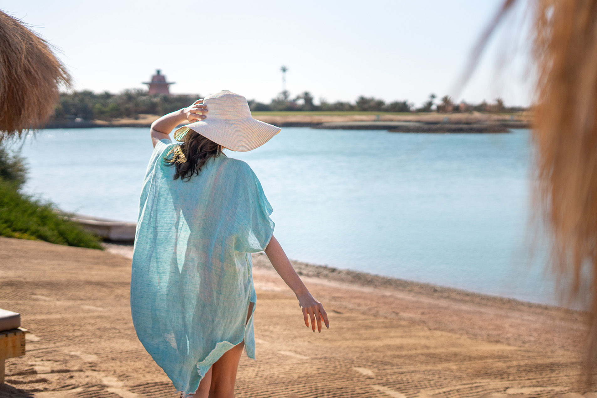 a girl enjoying the sun on a sandy beach