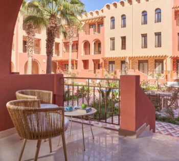 balcony with 2 seats and table garden view of Ocean View hotel