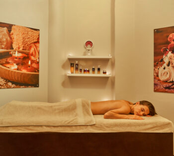 Female lying on a massage table at one of the treatment rooms at the Rihana Resort Spa