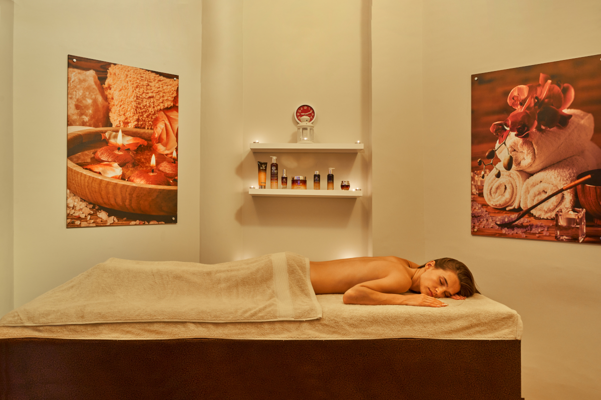 Female lying on a massage table at one of the treatment rooms at the Rihana Resort Spa