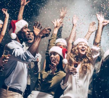men and women wearing Santa's hat and celebrating NYE