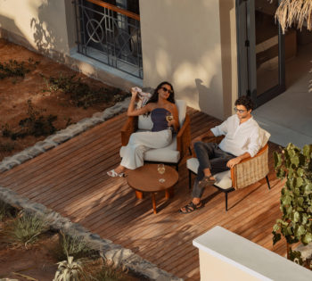 a couple sitting on the porch of their hotel room at the chedi el gouna hotel