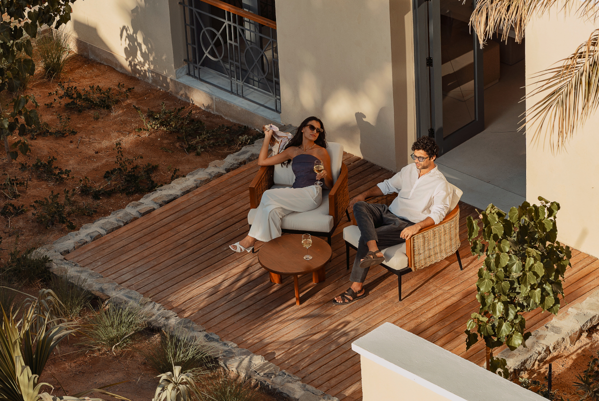 a couple sitting on the porch of their hotel room at the chedi el gouna hotel