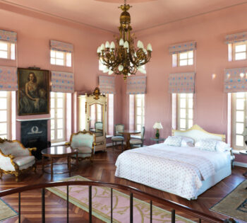 bedroom area with king bed, setting area inside tower suite in la maison blue