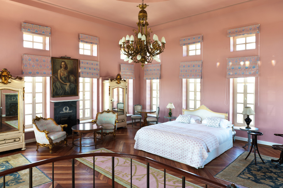 bedroom area with king bed, setting area inside tower suite in la maison blue