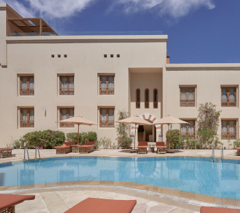 Picture of the Ali Pasha Hotel pool with long chairs and pool seating area.