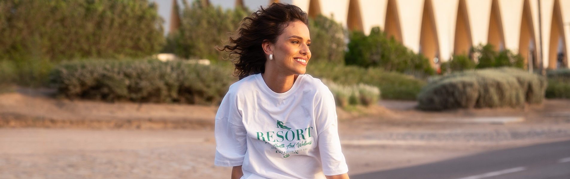 a girl sitting on the top of a car smiling in el gouna