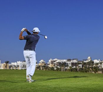 a man playing golf at ancient sands golf course